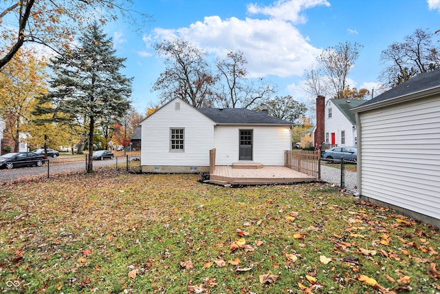 back of house with a yard and a deck