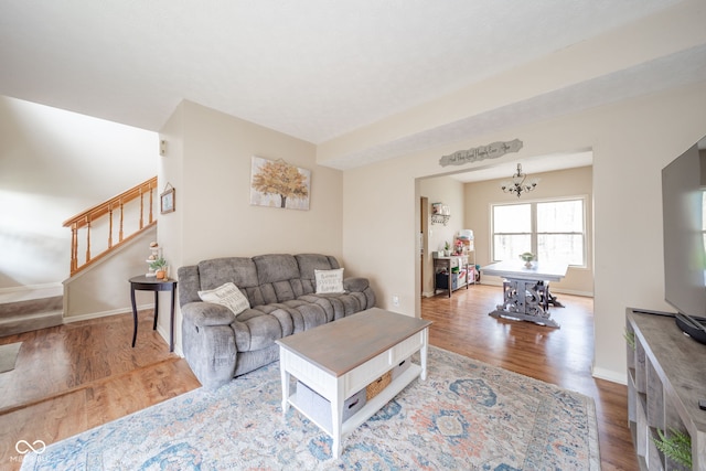 living room featuring hardwood / wood-style floors and an inviting chandelier