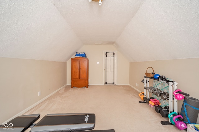 workout room with light carpet, a textured ceiling, and lofted ceiling