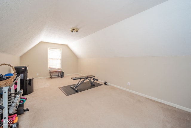 workout room with lofted ceiling and carpet flooring