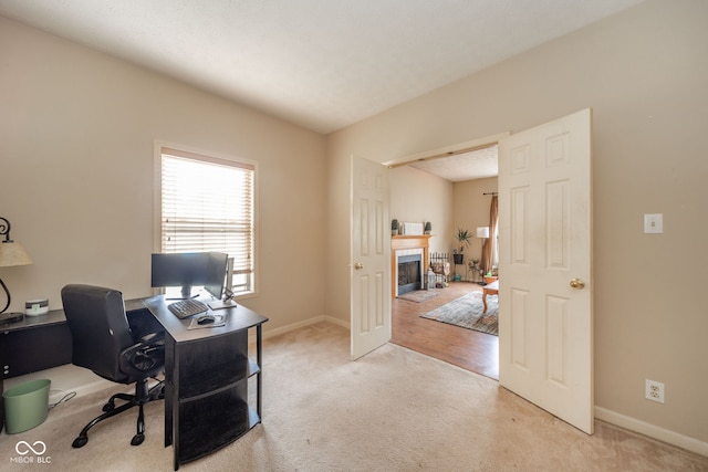 home office with a textured ceiling and light hardwood / wood-style floors