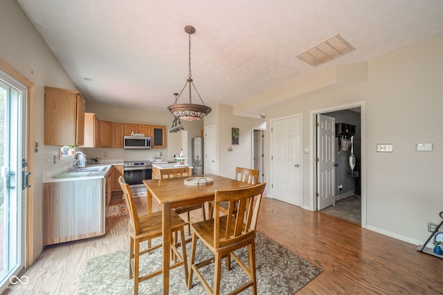 dining space with sink and hardwood / wood-style floors