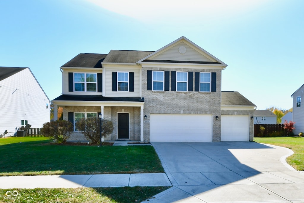 front of property with a front yard and a garage