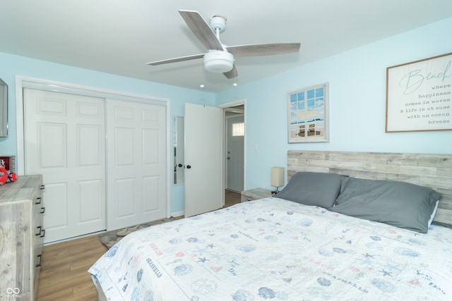 bedroom with hardwood / wood-style floors, ceiling fan, and a closet