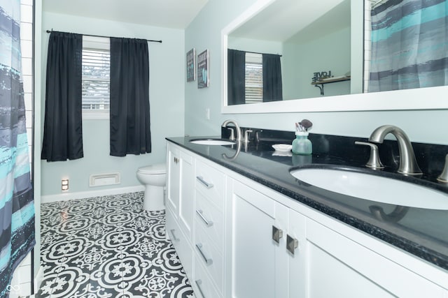 bathroom with vanity, tile patterned floors, and toilet