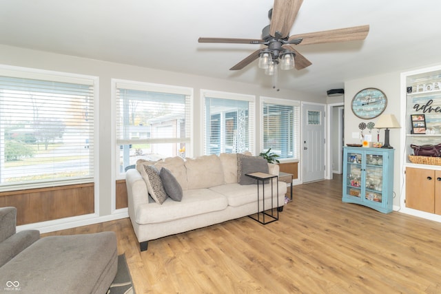 living room with ceiling fan, a healthy amount of sunlight, and light wood-type flooring