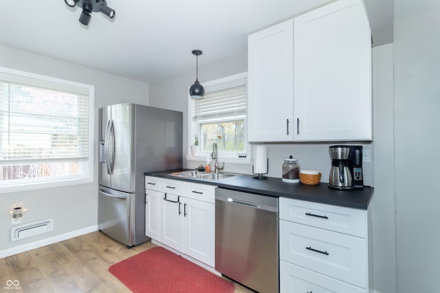 kitchen featuring light hardwood / wood-style flooring, plenty of natural light, sink, and stainless steel appliances