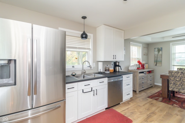 kitchen featuring light wood-type flooring, appliances with stainless steel finishes, and a wealth of natural light