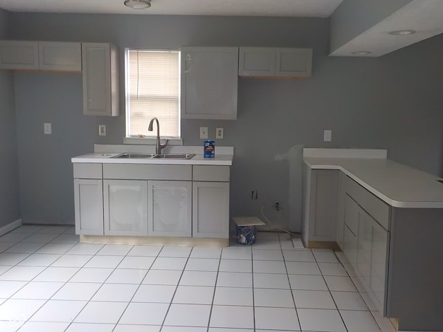 kitchen with light tile patterned flooring and sink