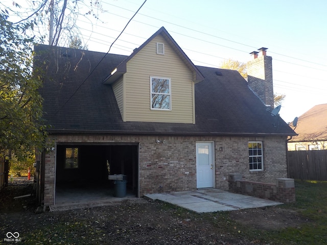 rear view of house with a garage