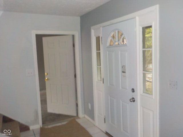 entrance foyer with light tile patterned floors