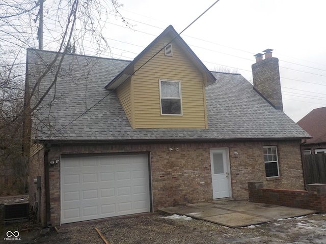 rear view of property with cooling unit