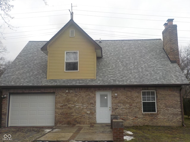 back of property featuring a garage