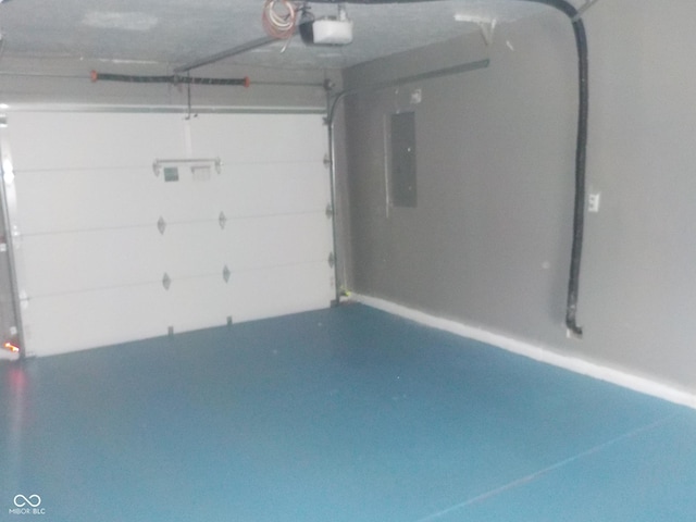 garage with a garage door opener and electric panel