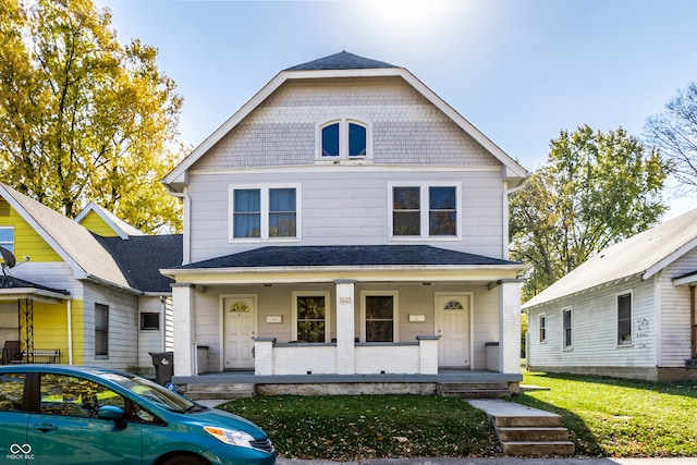 view of front of home featuring a front lawn and covered porch