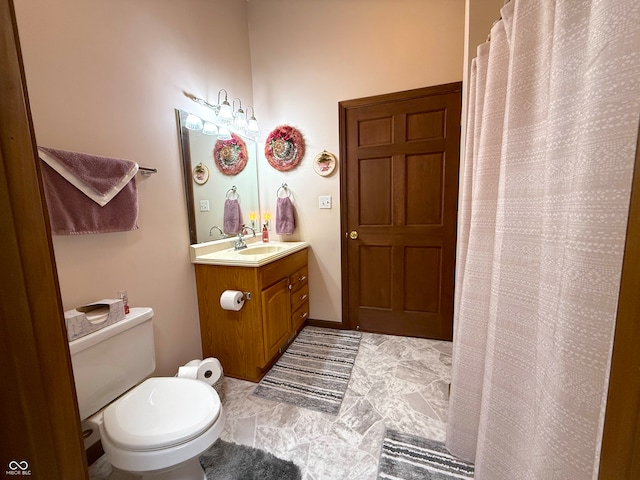 bathroom with vanity, walk in shower, and toilet