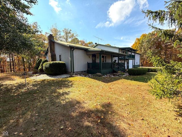 rear view of property with a yard