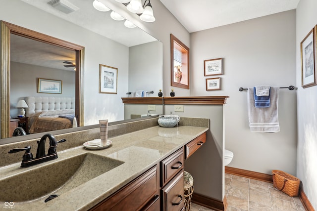 bathroom featuring vanity, toilet, and ceiling fan