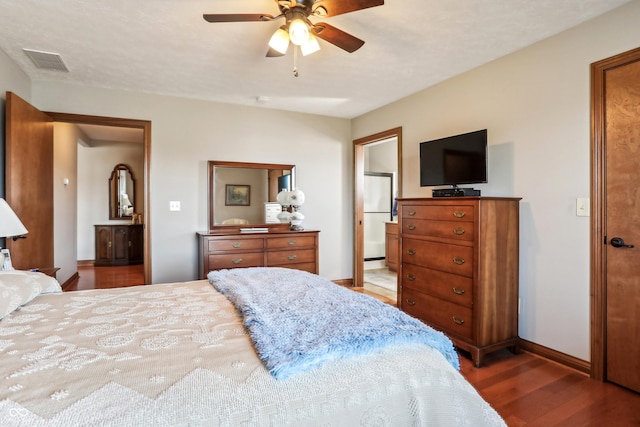 3784 Mansfield Dr, Brownsburg, IN 46112 - bedroom featuring wood finished floors, baseboards, ensuite bathroom, ceiling fan, and freestanding refrigerator