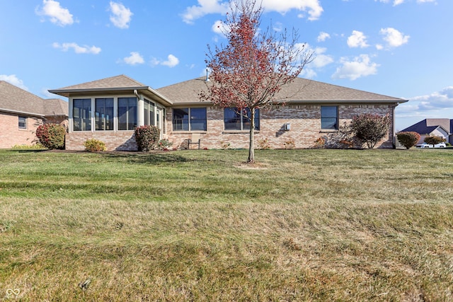 3784 Mansfield Dr, Brownsburg, IN 46112 - back of house with brick siding, a yard, and a sunroom