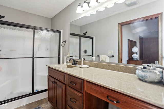 bathroom with vanity, tile patterned floors, and a shower with shower door