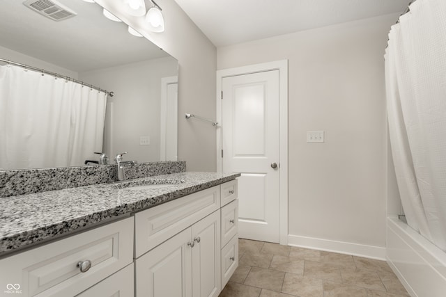 bathroom with vanity and shower / tub combo