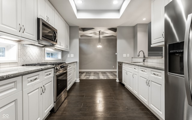 kitchen featuring white cabinetry, pendant lighting, dark hardwood / wood-style floors, and appliances with stainless steel finishes