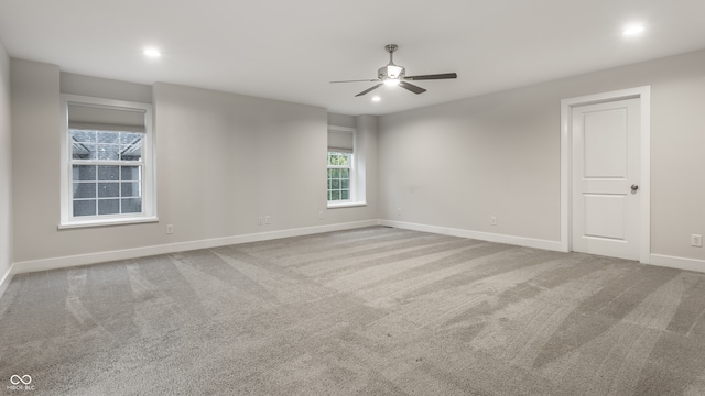 carpeted empty room featuring ceiling fan