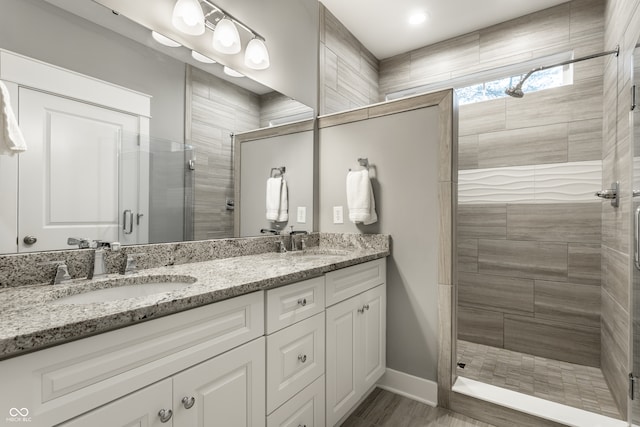 bathroom featuring vanity and an enclosed shower