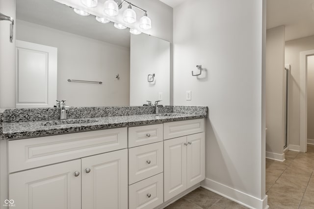 bathroom featuring tile patterned flooring, vanity, and walk in shower