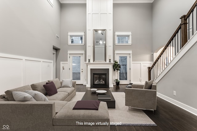 living room featuring a high ceiling and hardwood / wood-style flooring