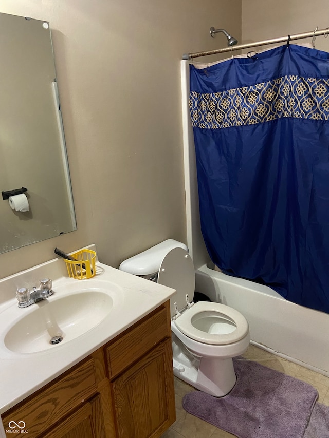 full bathroom with vanity, shower / bath combo with shower curtain, toilet, and tile patterned floors