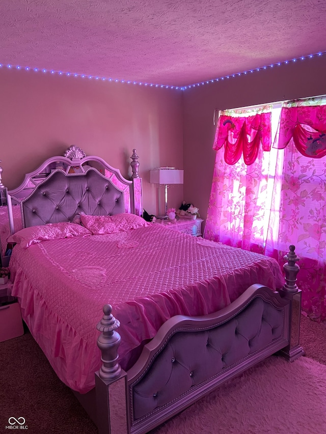 carpeted bedroom featuring a textured ceiling