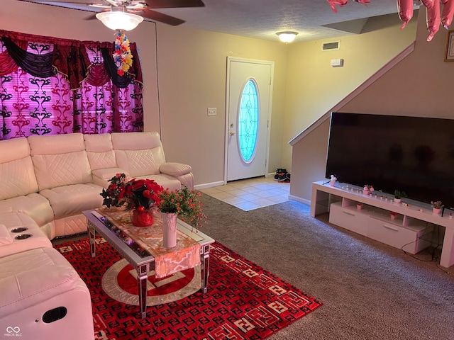 carpeted living room featuring a textured ceiling and ceiling fan