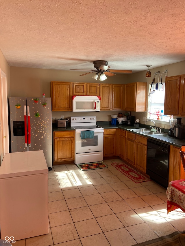 kitchen with white appliances, sink, a textured ceiling, ceiling fan, and light tile patterned floors