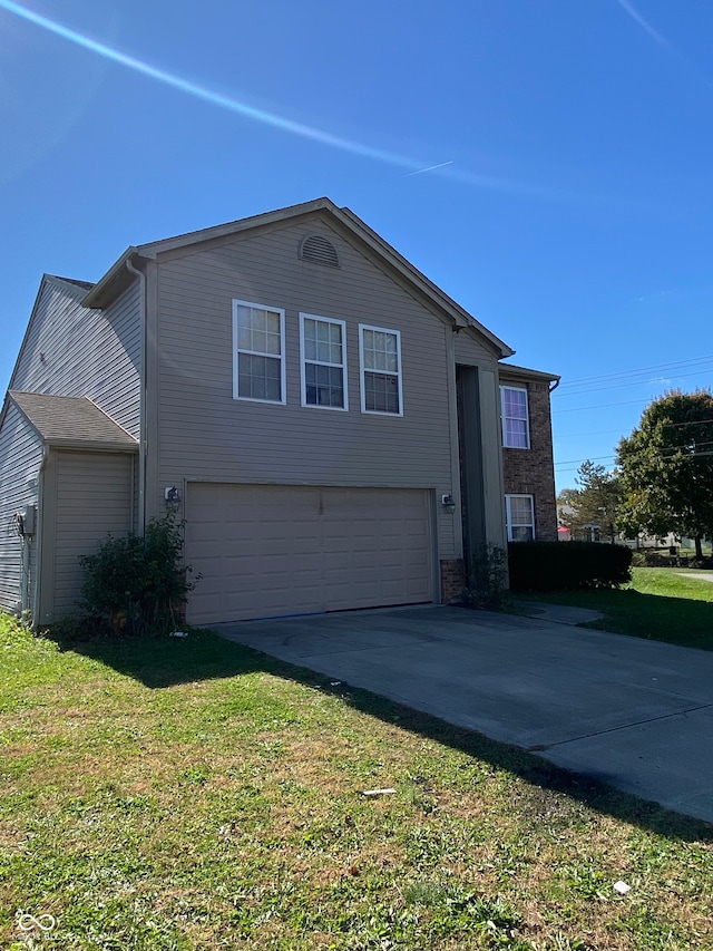 view of side of property with a yard and a garage