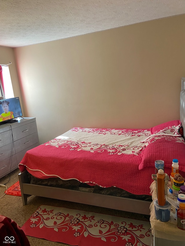 bedroom with a textured ceiling and carpet