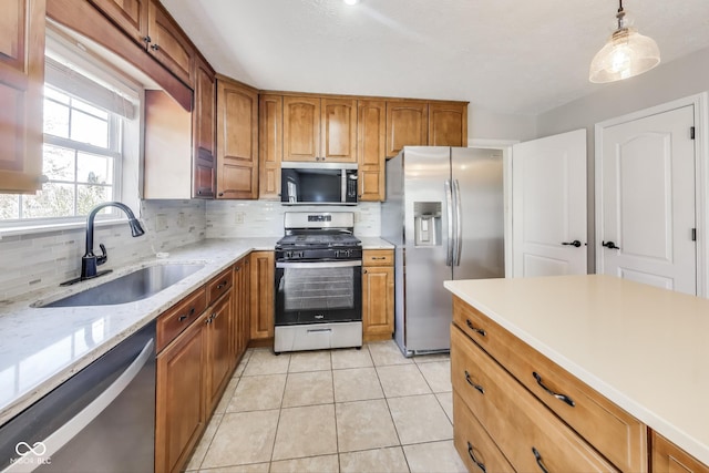 534 Austrian Way, Avon, IN 46123 - kitchen with stainless steel appliances, a sink, decorative backsplash, brown cabinetry, and light tile patterned floors