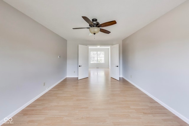 spare room featuring light wood-type flooring and ceiling fan