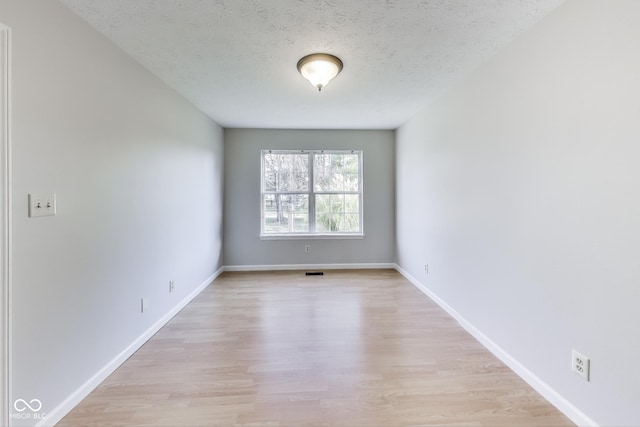 534 Austrian Way, Avon, IN 46123 - spare room with light wood-style floors, baseboards, and a textured ceiling