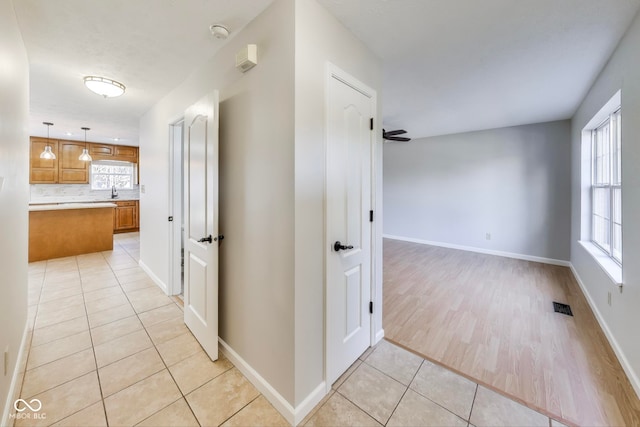 hallway with light hardwood / wood-style flooring