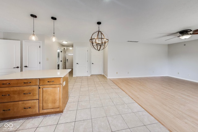 kitchen with light hardwood / wood-style flooring, decorative light fixtures, and ceiling fan with notable chandelier