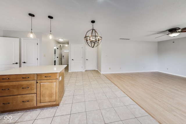 534 Austrian Way, Avon, IN 46123 - kitchen featuring ceiling fan, a chandelier, light countertops, hanging light fixtures, and light tile patterned flooring