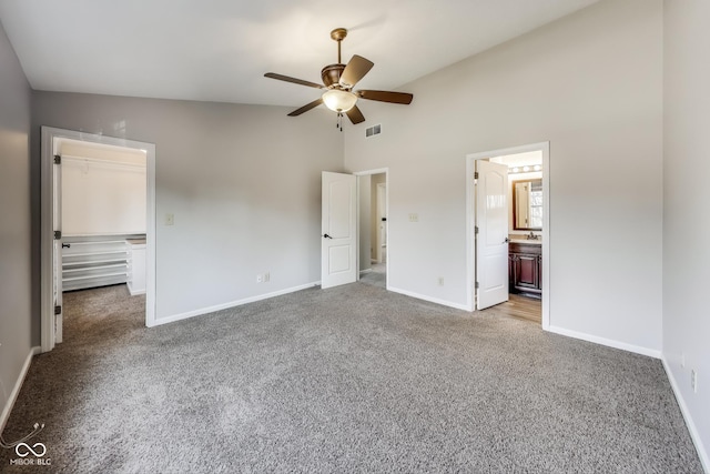 534 Austrian Way, Avon, IN 46123 - unfurnished bedroom featuring carpet flooring, a walk in closet, baseboards, high vaulted ceiling, and a closet
