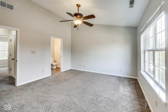 unfurnished bedroom featuring ensuite bathroom, carpet flooring, and vaulted ceiling