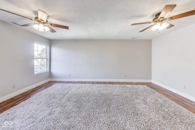 unfurnished room with dark hardwood / wood-style floors, a textured ceiling, and ceiling fan