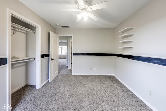 interior space with a closet, light colored carpet, and ceiling fan