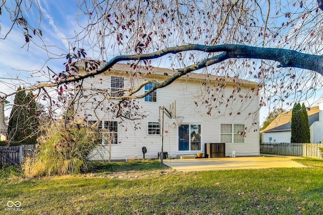 rear view of house featuring a patio and a lawn