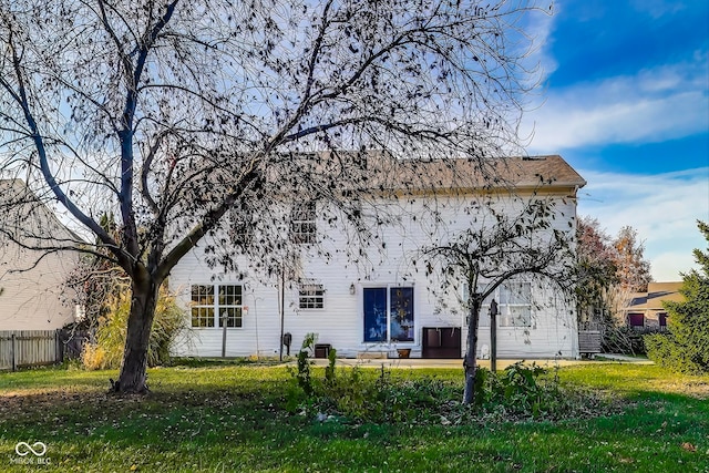 back of property featuring a patio and a lawn