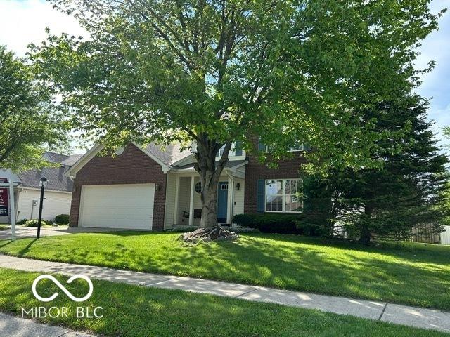 534 Austrian Way, Avon, IN 46123 - obstructed view of property with a garage, a front yard, and brick siding